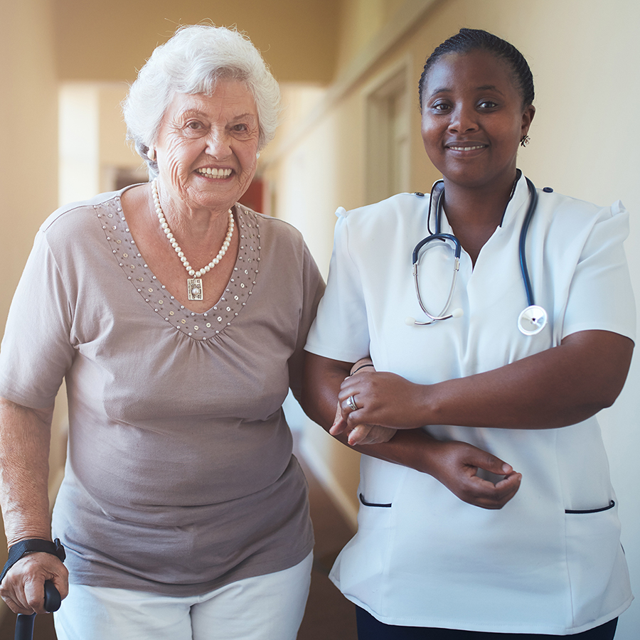 Elderly white woman with African American nurse